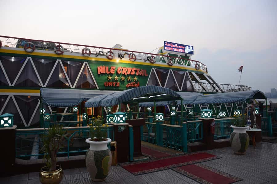 Cairo: Nile Sunset Dinner Cruise, Show & Optional Transfer - Boarding, seating, and the first view of Cairo