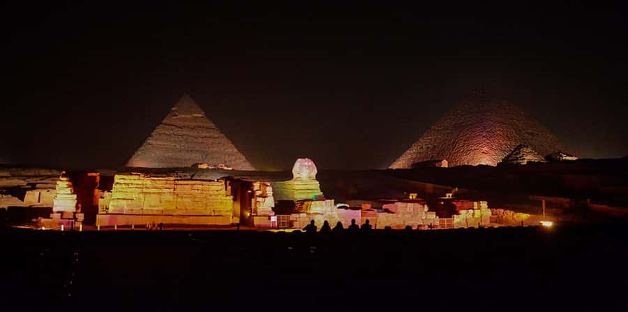 From Cairo: Giza Pyramids Tour with Light Show and Transfer - The pyramids after dark, with a stage built from stone