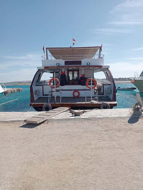 Hurghada: Dolphin & Coral Reef Snorkeling Tour with Lunch - Giftun Island, music, and the boat atmosphere
